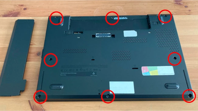 a diagram showing the positions of the 8 screws that need to be removed from the laptop