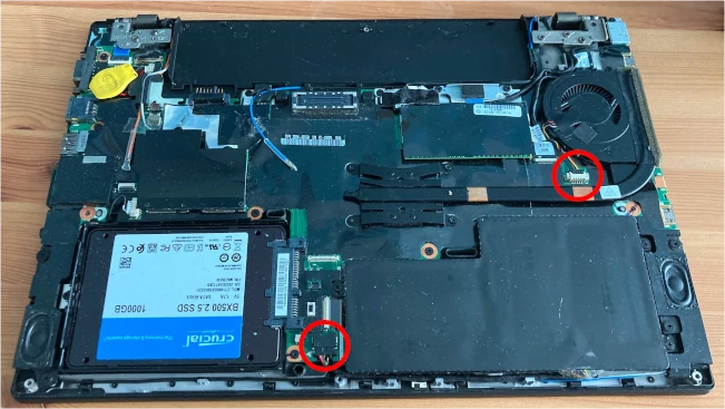 a photo showing the two connectors that need to be removed from the laptop in order to operate on it safely